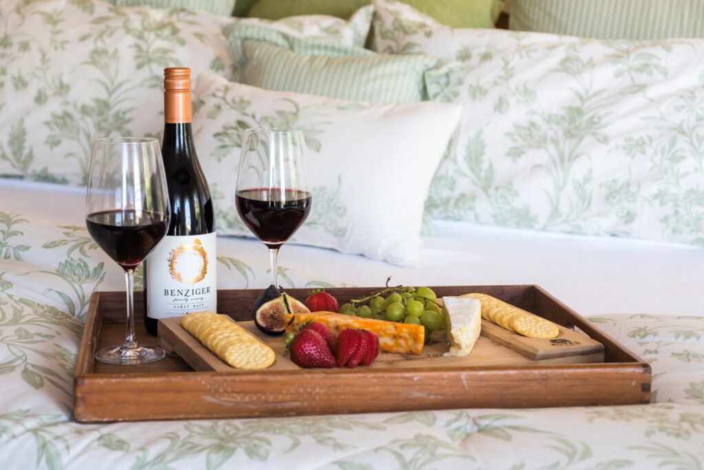 King bed with wine and cheese tray