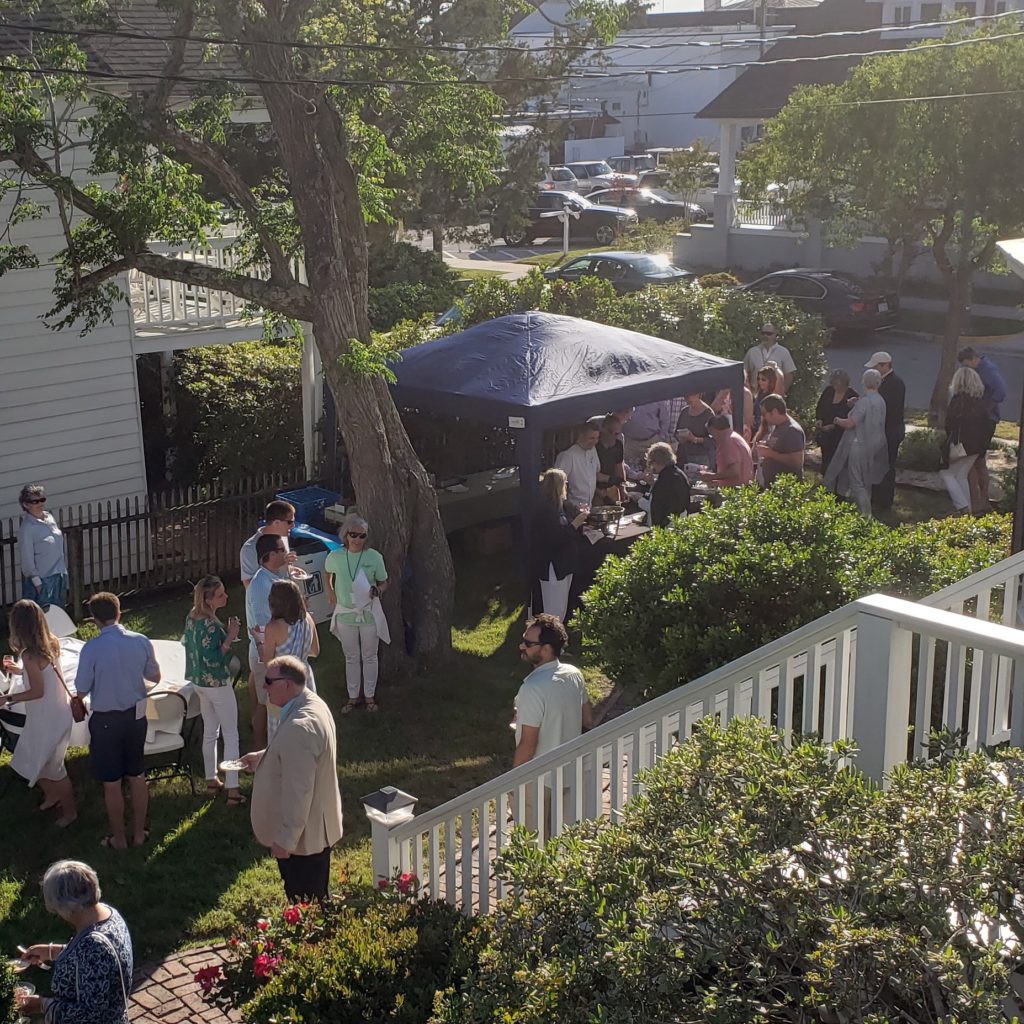 Individuals gathering on front lawn